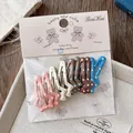 Détail du lot de 10 barrettes en forme d'étoile avec pois colorés en tons chauds - Style Météore