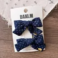 Detailed macro view of dark blue polka dot hair bows with gold hand made charms - Polka Dot Bow Style