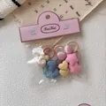 Vista detallada de pack de 10 gomas para el pelo con formas de corazón y estrella - Grupo Estrella Rosa