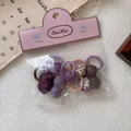 Detalle de 10 gomas para el pelo de niña con corazones y estampado de leopardo en bolsa - Set Morado