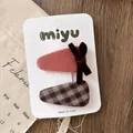 Detail of pink velvet and brown plaid bow hair clips on white display card - Triangle Plaid
