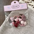 Set of 10 pink and red fabric hair ties with heart and button charms in a gift pack - Pink Heart