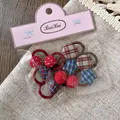 Detailed view of kids fabric hair ties with checkered hearts and stars in packaging - Blue Plaid Star