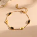 Detailed view of a gold-plated titanium steel bracelet with black gems and hearts - Hollow Heart Black Rhinestone Style (L713)