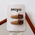 Pair of cute brown plush bear hair clips for girls on a white branded display card - Knitted Bear