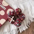 Detail of red floral velvet hair scrunchie with 3D flower shape and silk bow accent - Floral Scrunchie Style