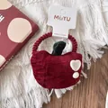 Detail of red apple velvet hair scrunchie with leaf and white heart on display card - Apple Style