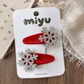 Detail of red velvet snap hair clips with sparkling rhinestone snowflake embellishments - Snowflake