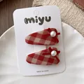Detail of red checkered BB hair clips with silk bows and pearls on a white display card - 3-Triangle Plaid