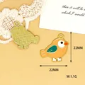 Detail showing 22mm x 22mm size and weight of small bird enamel charm pendants - Yellow Bird (L)