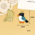 Detailed view of enamel bird charm pendant with dimensions 23mm by 20mm and weight 1g - Magpie (L)