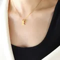 Collier chic avec pendentif lapin doré en acier titane porté sur mannequin en costume - 40+5cm / Or