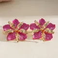 Detailed macro view of elegant pleated floral earrings with vibrant pink enamel finish - Steel Post Studs / Rose Red