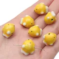 Handmade yellow ceramic fish bead for DIY jewelry making shown on a person's palm - Yellow Fish (17x14mm) / 1 Piece Per Pack