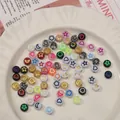 Flat acrylic beads for DIY jewelry with gold star and heart patterns in a white dish - Random Mixed Colors