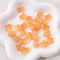 Orange translucent maple leaf glass beads for DIY jewelry making in a white ceramic dish - Approx. 16x15mm (Pack of 10) / Orange Yellow Gilded