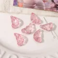 Pink butterfly shaped glass beads for DIY jewelry making displayed on a ceramic plate - 11x20mm (10 Pieces/Pack) / Transparent Pink