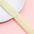 Strands of ivory white mother of pearl shell spacer beads in a flat round cylinder shape - 2x4mm Hole 0.8mm 38cm Per Strand Approx 180 Beads / Yellow
