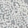Flat lay of half round mermaid AB white pearl beads for DIY craft hair accessories - 4mm / Pack of 1000 / Beige