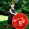 Close-up of 60-inch red birthday balloon with Happy Birthday 5 text on grass - Age 5 Theme Set / Red