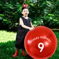 9th birthday party decoration with large red balloon and felt crown on grass background - Age 9 Theme Set / Red