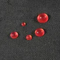 Five dark red resin cat-eye cabochons for DIY jewelry making on black fabric - Round (4mm) 50 Pieces/Pack / Red