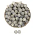 Gray resin beads with gold swirl patterns for DIY jewelry making on a gold tray - Gray