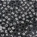 Macro shot of black acrylic square letter beads for DIY handmade jewelry crafting - Alphabet Beads / 6x6mm Hole 4mm 100 Pieces/Pack / Black with White Letters