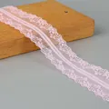Light pink polyester lace trim with delicate floral mesh pattern and scalloped edges for DIY - Pink