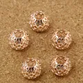 Five rose gold filigree mesh beads for DIY jewelry making on a textured wood surface - 9×10mm (6 Pieces/Pack) / Rose Gold