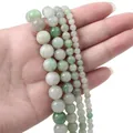 Natural green stone beads in mixed shades and sizes held in hand for jewelry making - Small Size / Green Agate