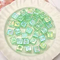 Light green transparent ice cube alphabet beads with aurora finish in ceramic dish - 12x12mm (10 Pieces/Pack - Random Letters) / Light Green