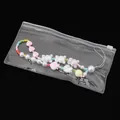 Colorful beaded phone strap with pink heart and bear charms in a clear PVC bag - 10 Pieces/Pack (20x10cm)