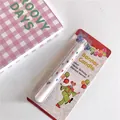 Musical surprise banner birthday candle with colorful balloon patterns in blister pack - Surprise Clown Style