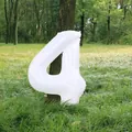 White number 4 foil balloon for 4th birthday party decoration in outdoor forest setting - Number 4