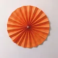 Detail of bright orange pleated paper fan flower with a central pearl for wedding decor - Small / Orange