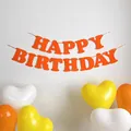 Close-up of orange Happy Birthday felt banner with decorative heart balloons for party decor - Orange