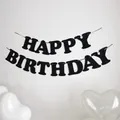 Detailed view of black felt Happy Birthday banner letters on string against white wall - Black
