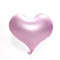 Close-up of a 22-inch matte pink heart-shaped aluminum foil balloon with a white string - Macaron Pink