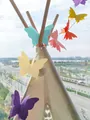 3D colorful butterfly garlands hanging on a white kids teepee for party decoration - Colorful