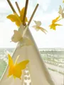 Close-up of 3D yellow and white butterfly paper garland hanging on a tent for party decor - Gradient Yellow