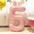 Close-up of 40-inch pearlescent pink number 5 foil balloon for birthday party decoration - Number 5