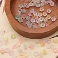 Détail macro de perles fleurs en acrylique 6x3mm avec feuille d'or pour bijoux DIY - Environ 6x3mm, Trou 1mm, 10g/Paquet (Environ 110 Pcs) / Multicolore