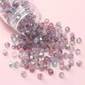 4mm light purple AB coated glass bicone beads spilled from a transparent jar - Violet