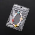 Ozean-Perlenarmband mit Seestern-Anhängern in einem klaren PVC-Druckverschlussbeutel - Kleiner Stil