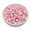 Pink pearlescent lily flower charms in a bowl for DIY jewelry and bracelet making - Lily of the Valley / Pink