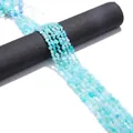 Light blue irregular natural stone beads for DIY jewelry making on black display stand - Amazonite