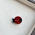 Detail of cute red ladybug hair clip with black spots made of glossy resin material - Red Ladybug