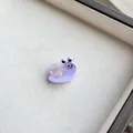 Macro view of a cute resin snail hair clip with a purple translucent shell texture - Purple Snail
