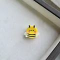 Cute yellow bee resin hair clip with black stripes and pearlescent wings on gray fabric - Bee